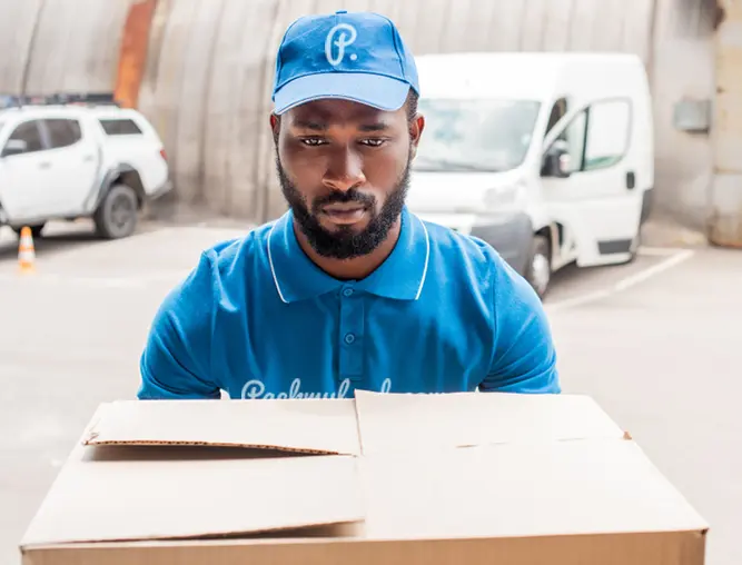 Packmyload employee holding a box ready for a move